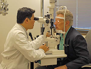 Doctor examining man's eyes.