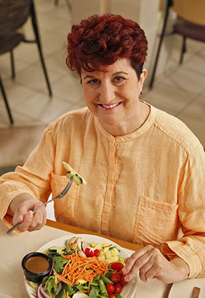 Woman eating salad.