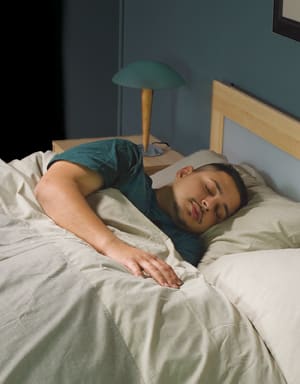 Person sleeping in bed.