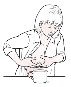 Female hand-expressing breast milk.