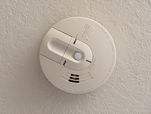 Smoke and carbon monoxide detector on ceiling.