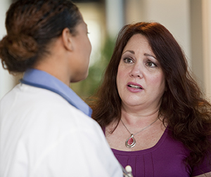 Woman talking to healthcare provider.