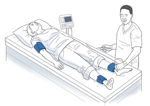 Person lying on examination table with blood pressure cuffs on ankles and upper arm as health care provider presses instrument against their foot.