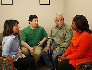 Group of two men and two women talking together.