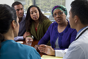 Woman and family talking to healthcare providers.