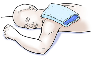 Man lying face down with ice pack on shoulder.