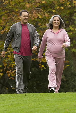 Man and woman walking together in a park