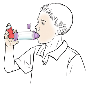 Boy using metered-dose inhaler with spacer.