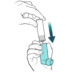 Hand holding inhaler upright, with other hand pushing down on canister, sliding it back into inhaler.