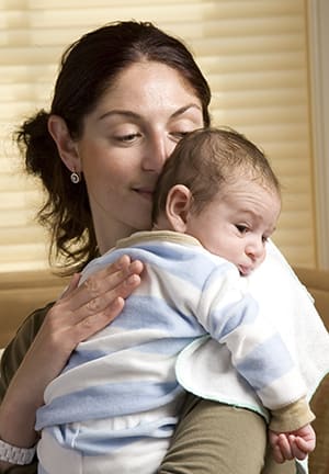 Woman holding newborn baby.