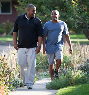 Two men walking outdoors.